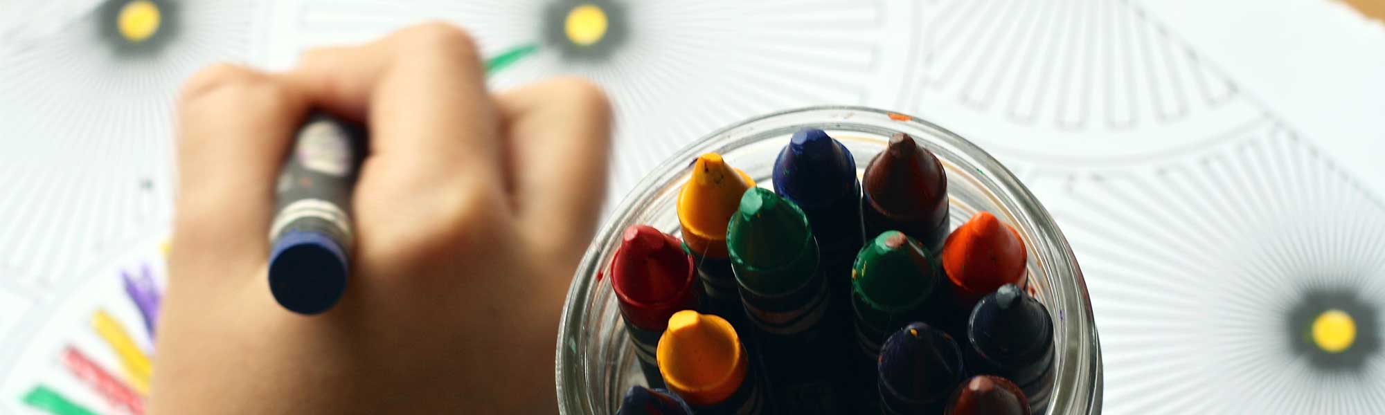 Image of kids with crayons depicting Signature of Hope's 'our stories'